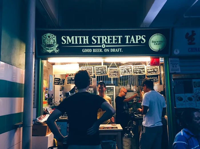 A patron stands at the Smith Street Taps stall.