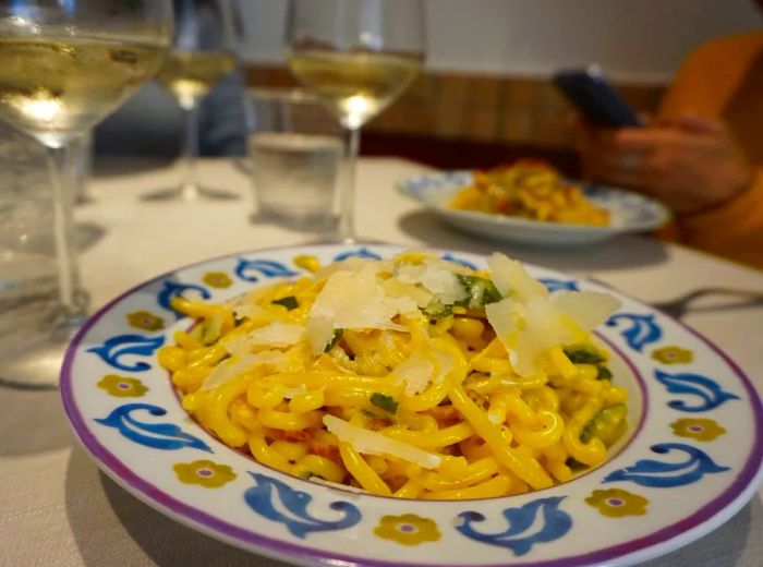 A beautifully presented plate of pasta in an elegant dish.