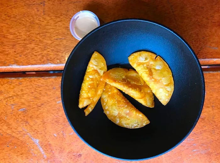 A serving of empanadas on a plate.