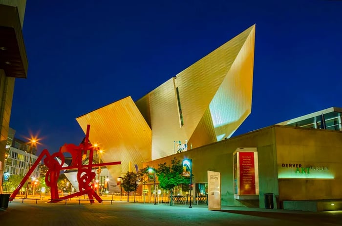 Nighttime view of the Denver Art Museum's exterior, beautifully illuminated