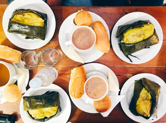 Dishes featuring tamales paired with hot chocolate.