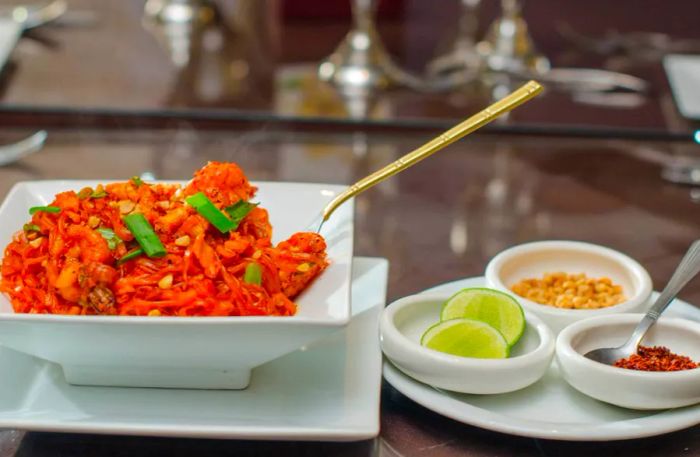 Plates adorned with vibrant orange dishes and garnishes.