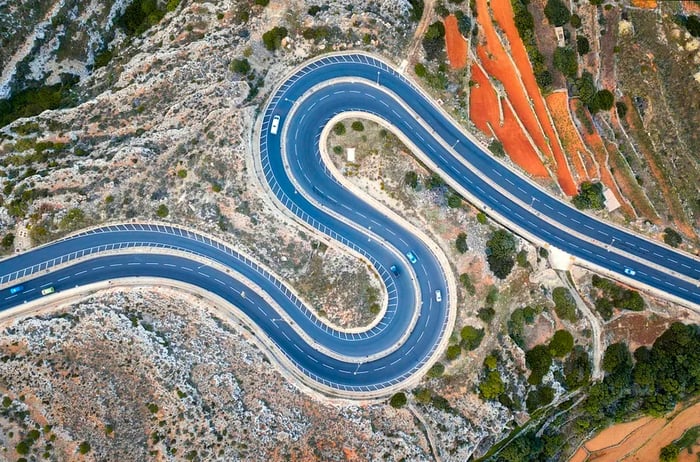 Aerial view of winding curves on a mountain road in Malta, Europe.