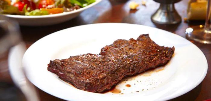 A beautifully cooked well-done steak on a plate.