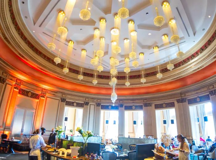 A fisheye perspective of the dining room, capturing an intricate, multi-part chandelier above.