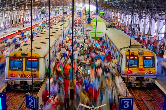 Travelers boarding trains at Mumbai's Chhatrapati Shivaji Maharaj Terminus.