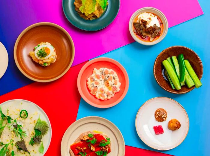 From above, a variety of dishes displayed against a vibrant geometric backdrop.