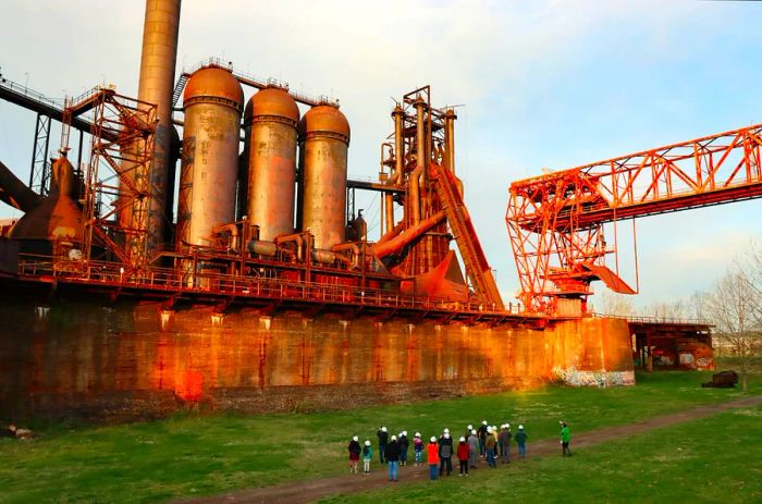 Visitors marvel at the towering Carrie Blast Furnaces, remnants of a once-mighty steel production facility along the Monongahela River in Pittsburgh