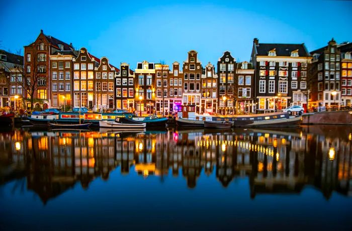 Historic homes lining the Singel canal after dark, Amsterdam, Netherlands