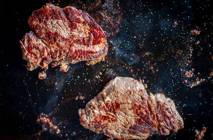 Two juicy steaks sizzling on the grill.