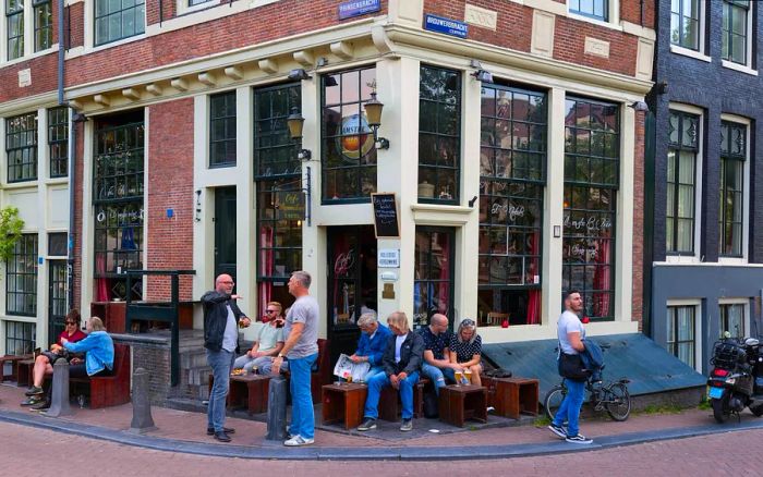 Tourists and locals gather at the iconic Dutch café Papeneiland in central Amsterdam, the Netherlands.