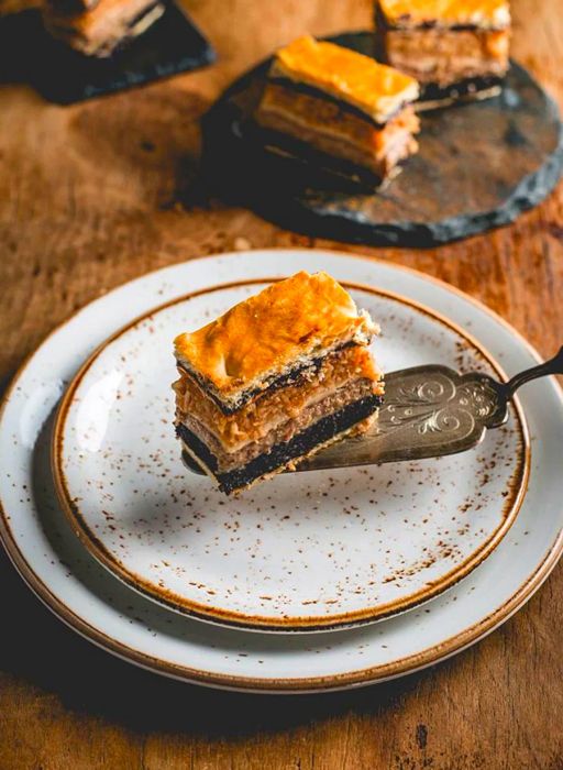 A slice of layered cake resting on a cake server.