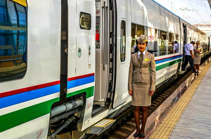 A female train conductor at the Afrosiyob train entrance