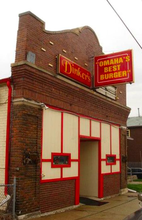 A charming red brick Tudor facade displaying a sign that says “Dinkers” along with another proclaiming “Omaha’s Best Burger.”