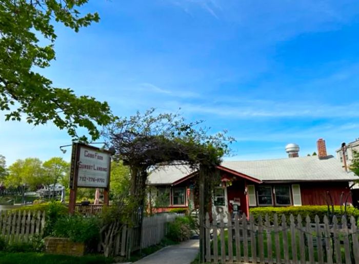 The exterior of a diner nestled beside a tranquil lake.