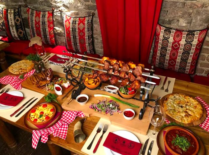 A beautiful arrangement of dishes, featuring skewered meats surrounded by soft, textured pillows.