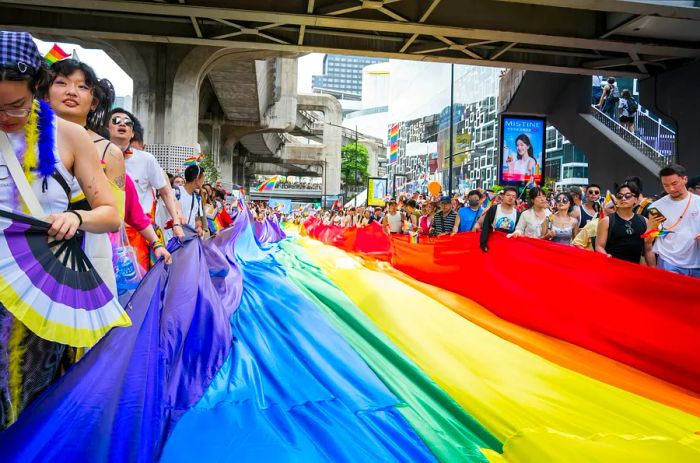 Bangkok Pride Festival 2024 captures the vibrant atmosphere of people celebrating in Siam Square, Bangkok, Thailand.