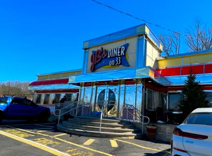 The exterior of a gleaming diner.