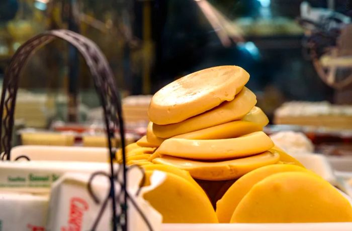 Circular pieces of dough stacked on a countertop.