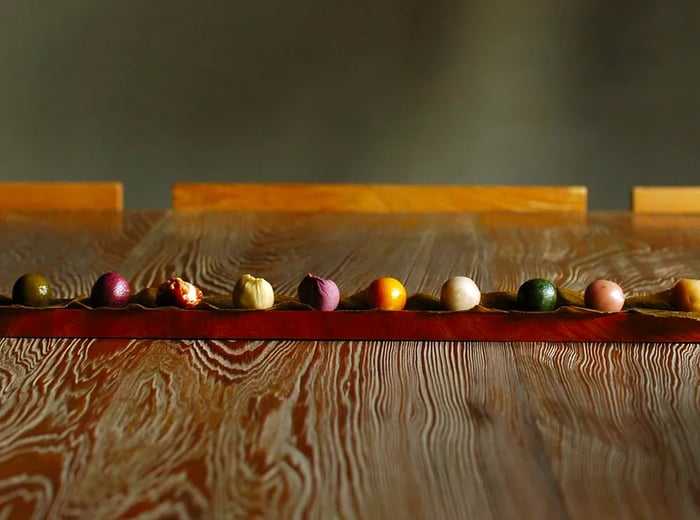 A vibrant assortment of colorful truffles arranged neatly on a wooden surface.