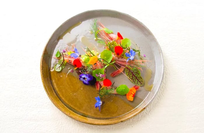 A vibrant plate adorned with a spectrum of fresh flowers, seen from above.