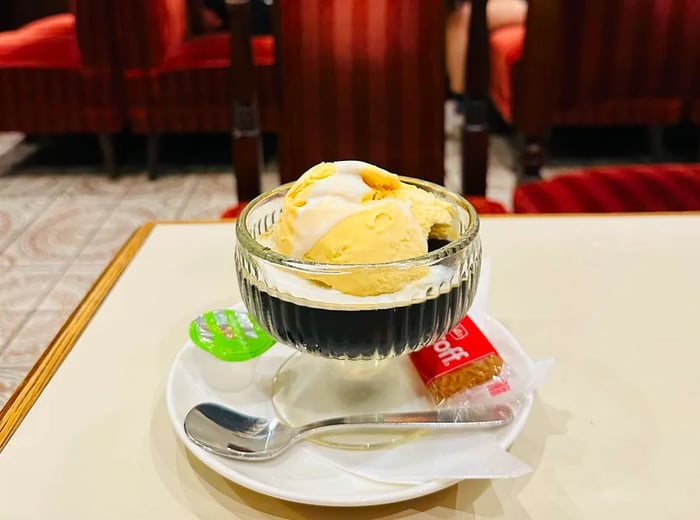 A serving of coffee jelly topped with a generous scoop of vanilla ice cream.