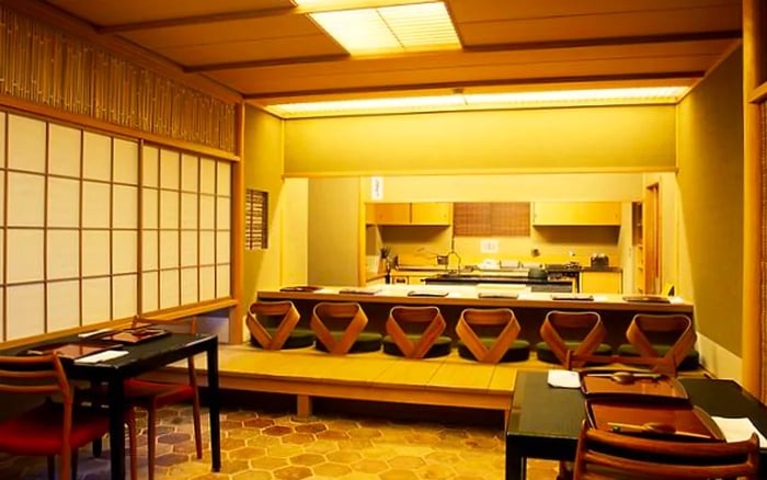 A dining area featuring a raised section with a tatami mat for traditional seating.