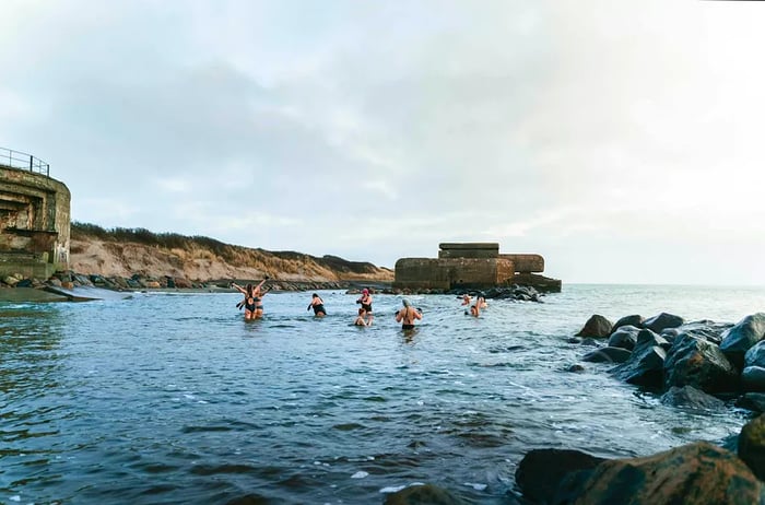 People enjoying a swim in the sea at Skagen, Denmark