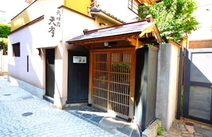 The exterior of a restaurant showcasing its signage and gated entrance.