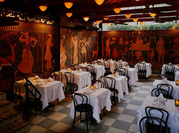 A dining area featuring expansive Etruscan-style murals adorning the walls, elegantly set tables with white linens, bentwood chairs, and stylish orb pendant lights overhead.