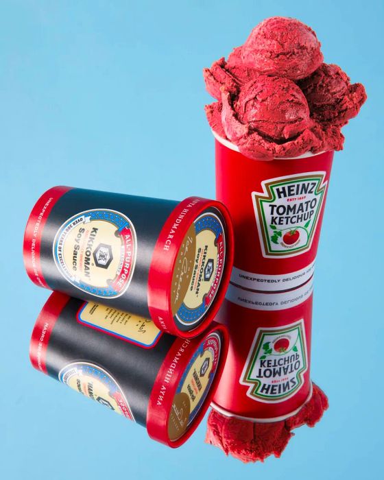 An open tub of Heinz Ketchup ice cream flaunting vibrant red scoops, next to a sealed tub of Kikkoman soy sauce ice cream.