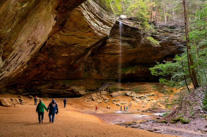 Visitors explore Ash Cave at Hocking Hills State Park, Ohio, USA