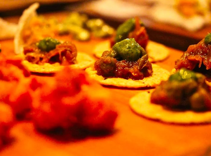 A selection of small bites arranged on a preparation table.