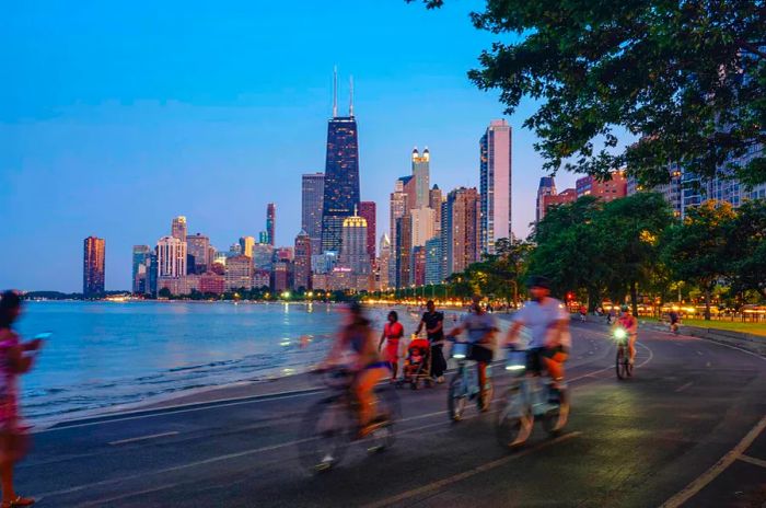 People biking under the stars along Lake Michigan, Chicago, Illinois, USA