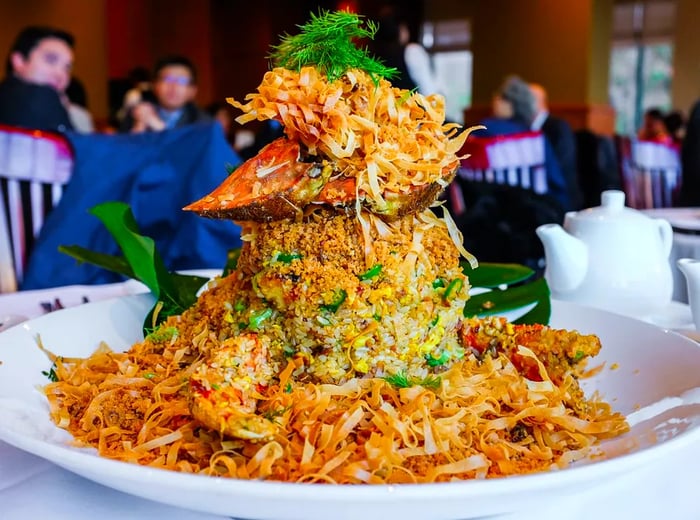 A crab shell atop a mound of crab and rice.