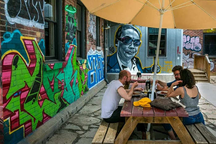 Guests savor the outdoor patio at 12 Bones Smokehouse barbecue restaurant in the River Arts District, Asheville, North Carolina, USA