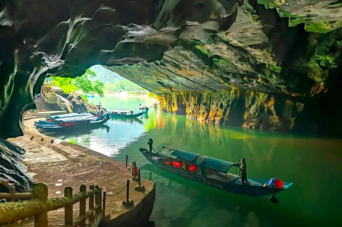 Boats navigating through Phong Nha Cave, located in the UNESCO World Heritage Site of Phong Nha-Ke Bang National Park in Vietnam.