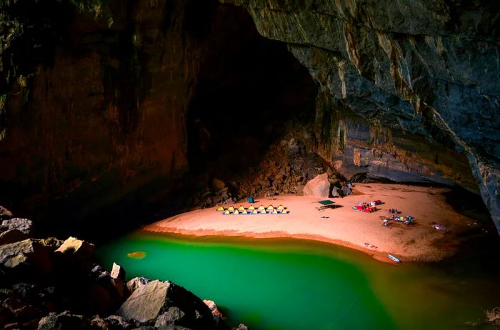 Campsite along the beach beside a small lake within Hang En Cave.