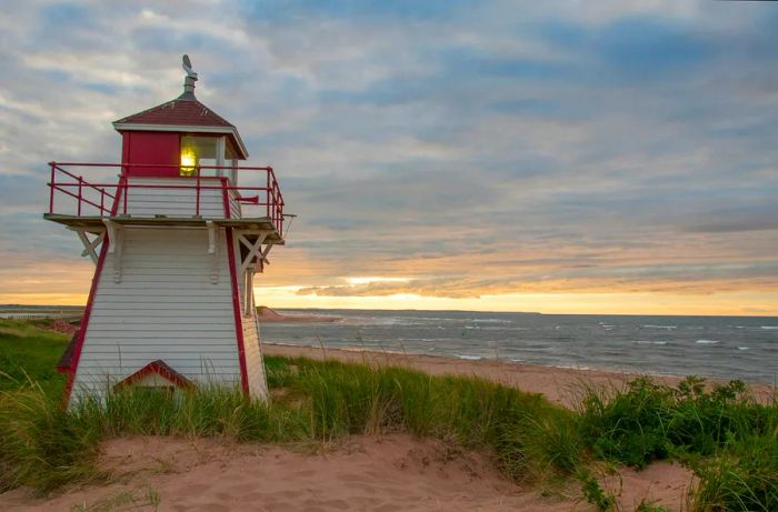 The sun sets behind the Covehead Lighthouse in Stanhope, Prince Edward Island.