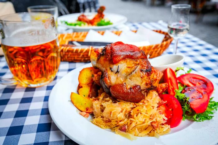 A platter featuring cabbage, salad, and potatoes, highlighted by a large piece of pork