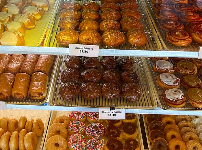 A display case filled with an array of doughnuts.