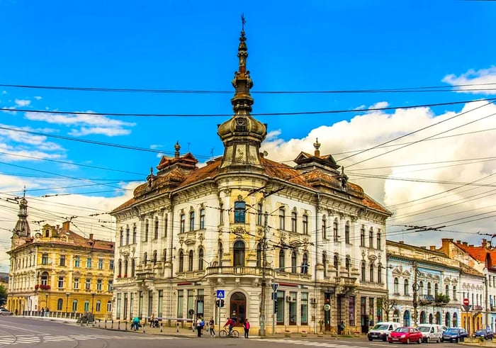 The Palace of Babos in Cluj-Napoca features an elaborate spire on its exterior.