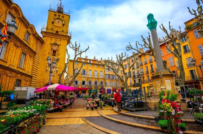 Visitors stroll through the vibrant flower market in the historic Old Town of Aix.