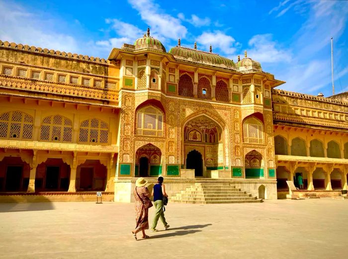 Visitors stroll past the magnificent Ganesh Pol at Amber Fort in Rajasthan.