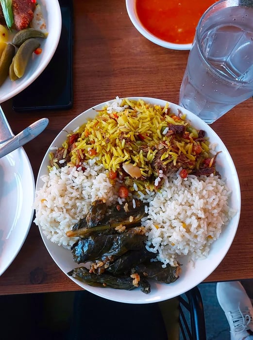 A plate of grape leaves stuffed with a variety of rice blends.