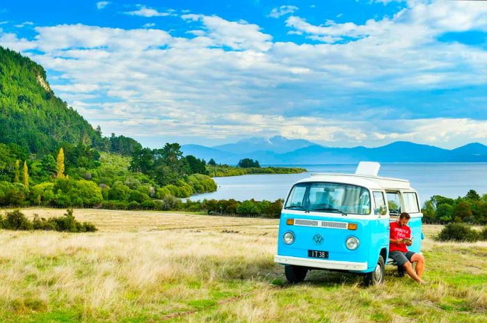 A camper van parked by Lake Taupo, North Island, New Zealand