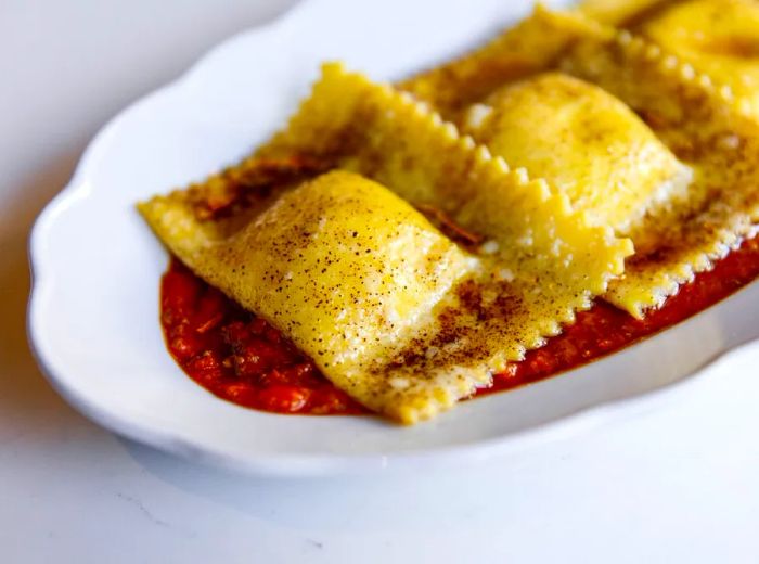 Three tender pieces of stuffed pasta smothered in a rich red sauce.