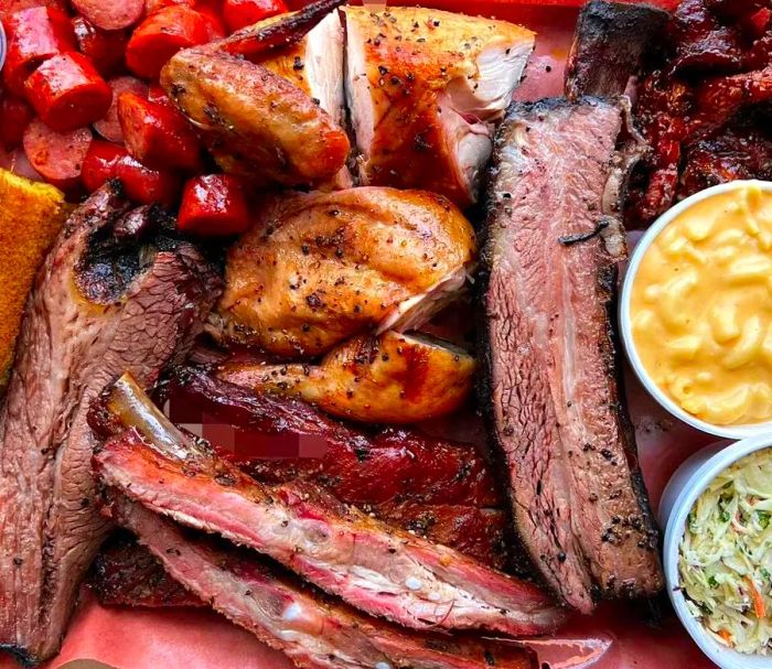 A platter showcasing a variety of barbecued meats accompanied by sides.