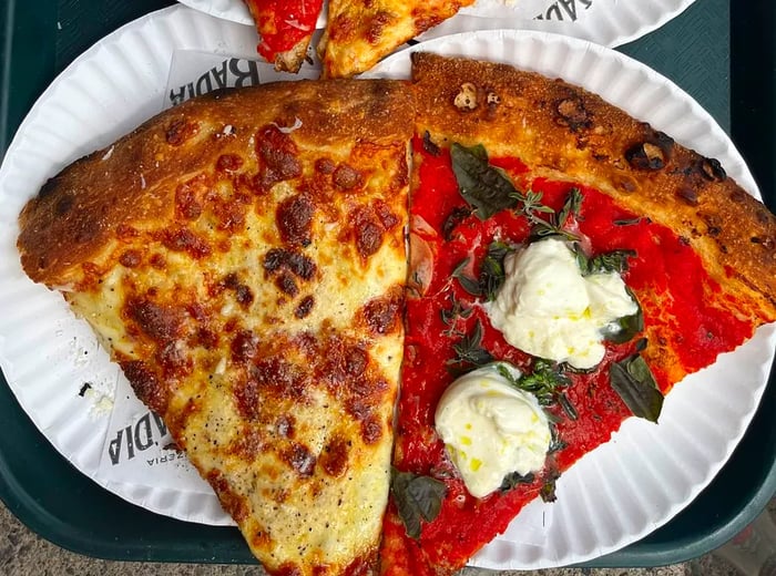 A selection of four pizza slices adorned with various toppings.