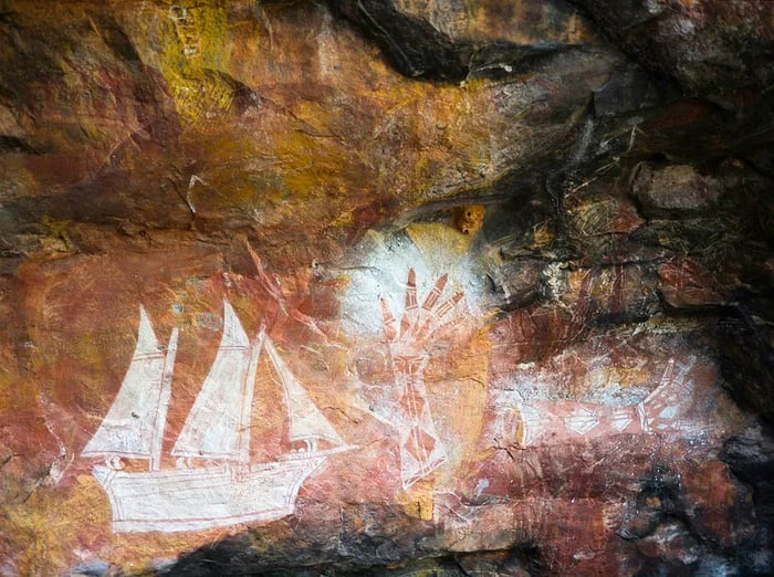 An Aboriginal rock art piece in Arnhem Land Art features a Macanese sailing ship, showcasing cultural intersections in Australia.